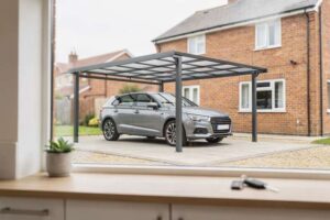 Modern carport structure sheltering a vehicle on a residential UK driveway.