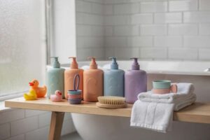 Colorful bath toys and gentle cleansing products arranged on a white bathroom shelf for kids.