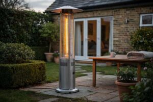 Modern patio heater glowing on a British garden terrace during evening hours.