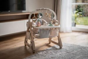 Colorful baby activity center with hanging toys and sensory features for infant development.