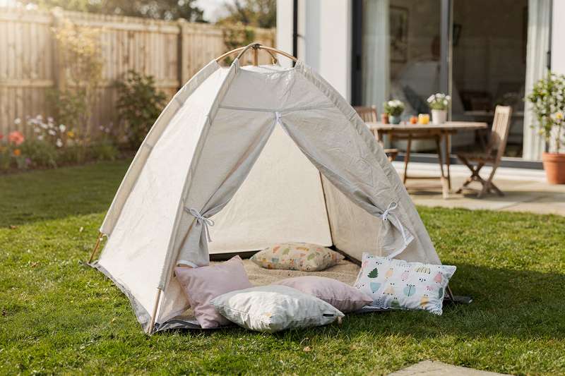 Colorful play tents arranged in a living room setting showcasing different styles and sizes for children.