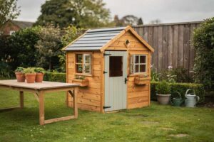Wooden playhouses arranged in a garden setting with different styles and sizes displayed for comparison.