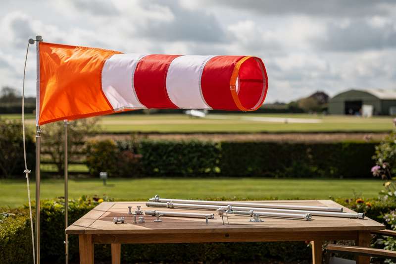Colorful windsock fabric displays wind direction and speed indicators for outdoor agricultural and aviation use.