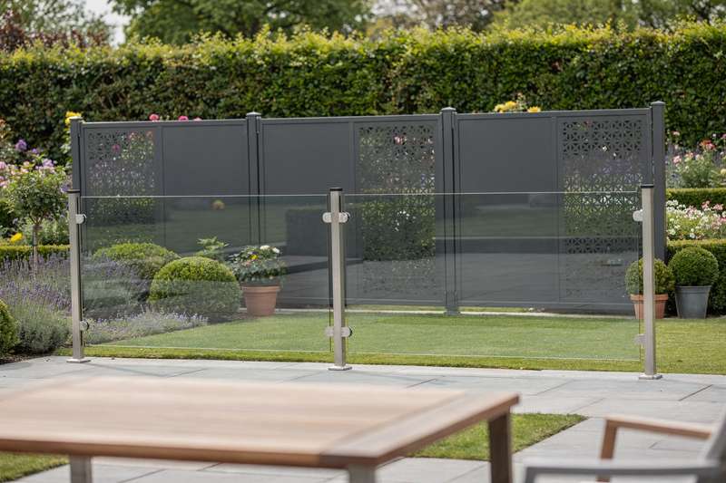 Modern outdoor privacy screens and garden shelters displayed in a contemporary UK garden setting.