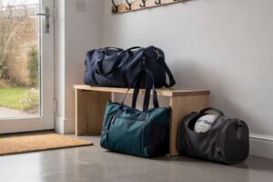 Selection of netball kit bags, tote bags, and ball carriers displayed together for UK players.