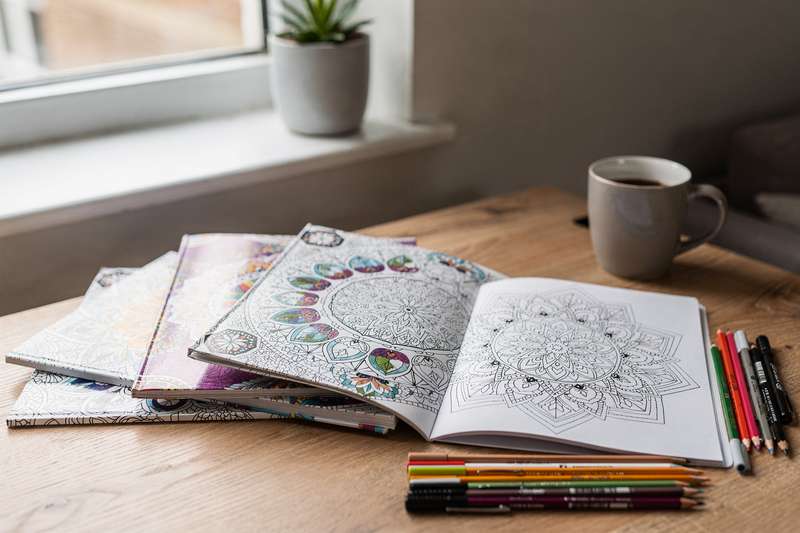 Adult mandala colouring book with intricate geometric patterns and detailed designs for relaxation.