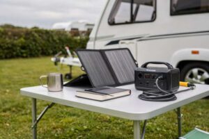 Solar panel kit mounted on top of a caravan roof for off-grid power generation.