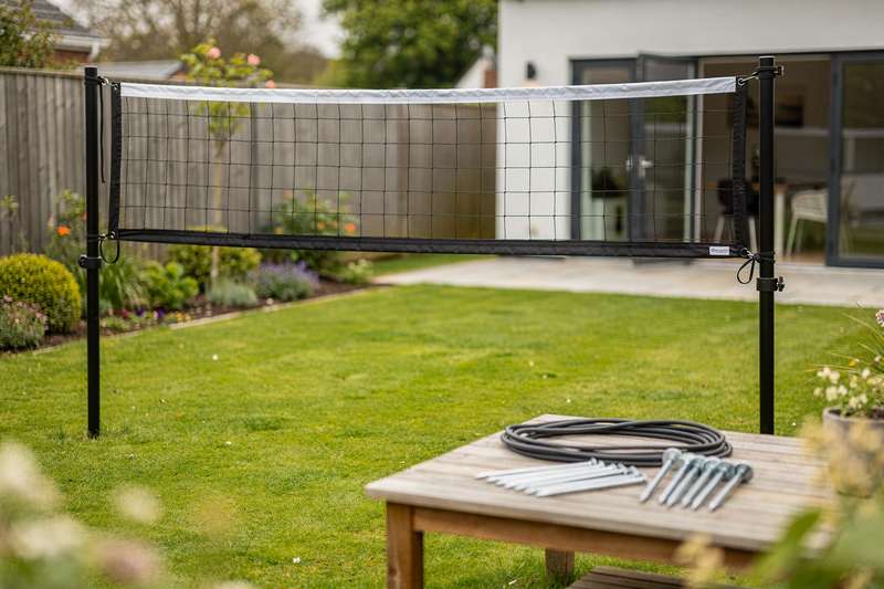 Professional and recreational volleyball nets set up in a UK garden for outdoor training and casual play.