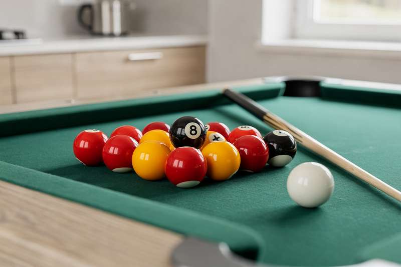 Selection of colorful billiard balls arranged for UK pool table play and competition.